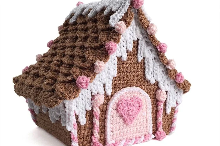 A Crocheted Candy Cottage on a White Surface