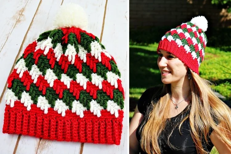 A woman is wearing a crocheted hat with a pom pom.