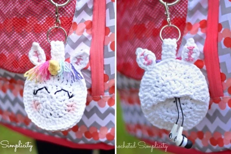 A crocheted unicorn keychain hanging from a backpack.