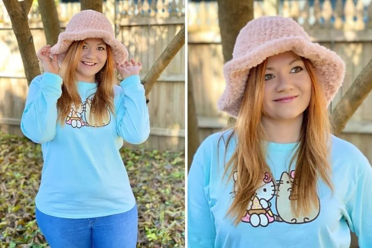 A girl wearing a pink hat and t - shirt.