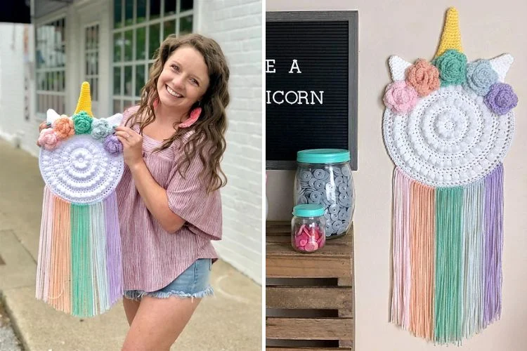 A woman is holding a crocheted unicorn tassel.