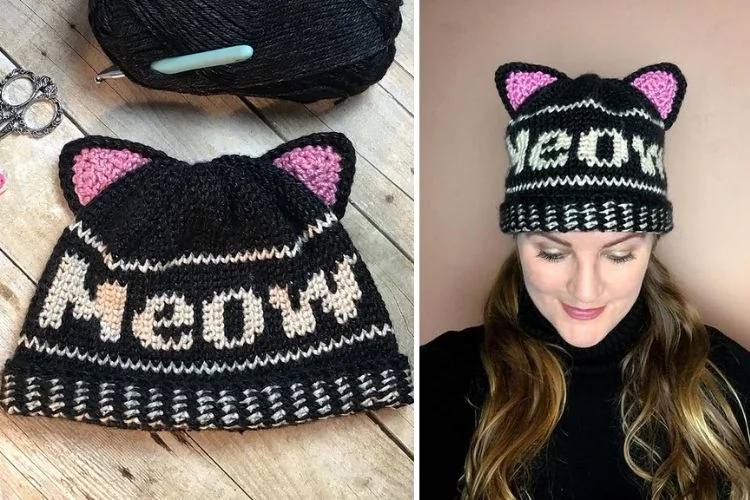 A woman is knitting a hat with the word meow on it.