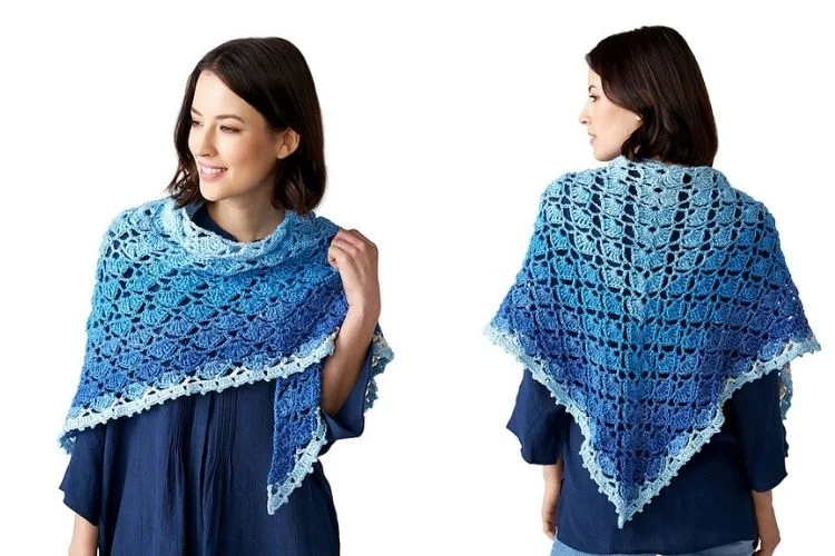 A woman wearing a blue crocheted shawl.