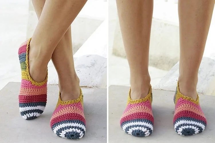 A pair of crocheted socks on a woman's feet.