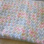 a delicate crochet baby blanket