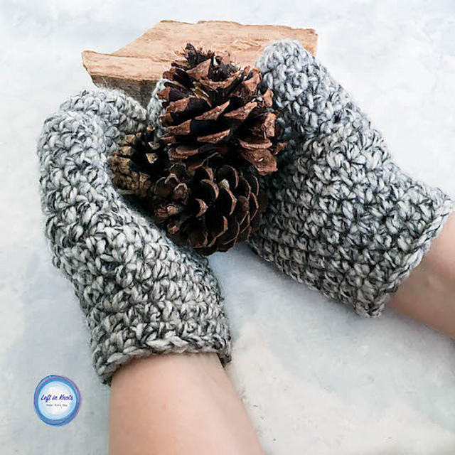 A pair of hands wearing Women's Basic Bulky Mittens in chunky gray crochet holds two pinecones against a light background with a piece of wood.