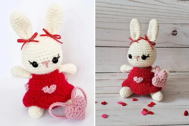 A crocheted bunny in a red dress next to a heart.