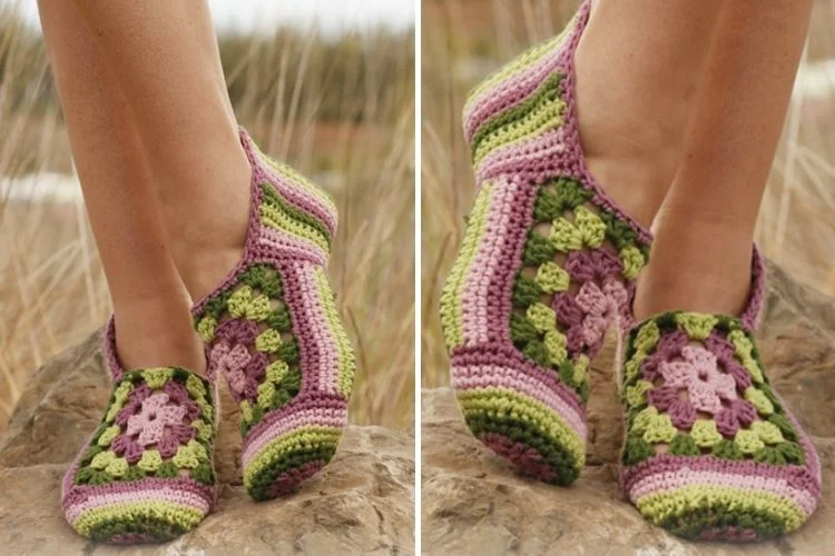 A pair of crocheted slippers on a rock.