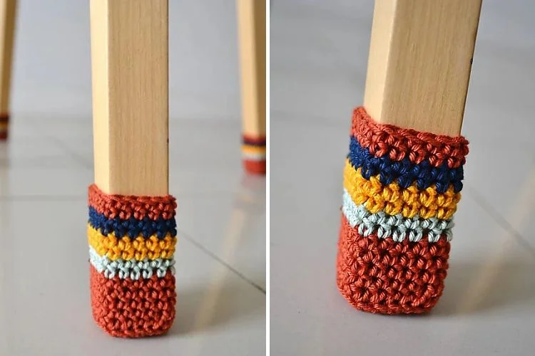 A pair of crocheted feet on a wooden chair.