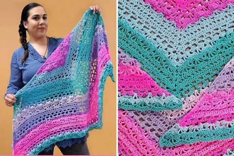 A woman is holding up a crocheted shawl.