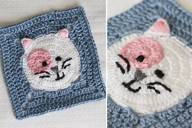 A crocheted square with a cat face on it.