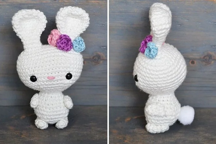 A white crocheted bunny with flowers on his head.