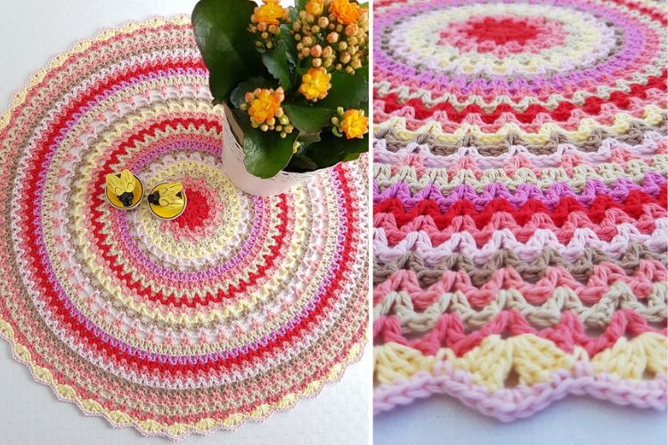 A crocheted round rug with a flower in the middle.