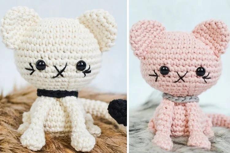 Two crocheted amigurumi cats in pink and black.