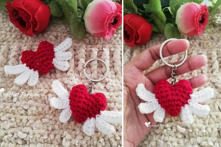 A crocheted heart with wings attached to a keychain.