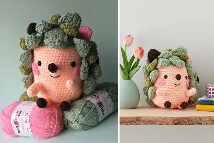 Crocheted plush toy resembling a cheerful hedgehog with a floral decoration, displayed alongside yarn and next to a vase of tulips.