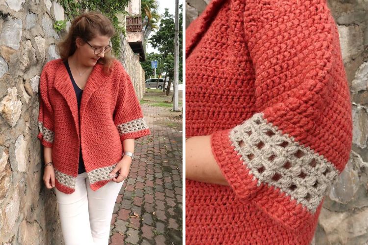 A woman wearing a red crocheted cardigan featuring a grey trim detail.