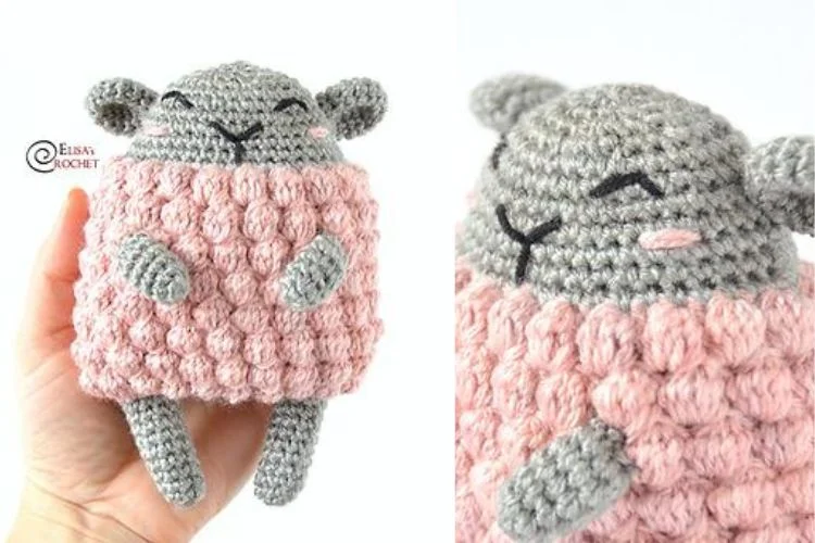 A crocheted sheep wearing a pink sweater.