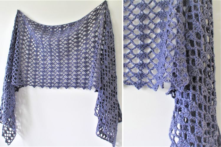 Handcrafted blue crochet shawl with detailed pattern design, displayed against a white background.