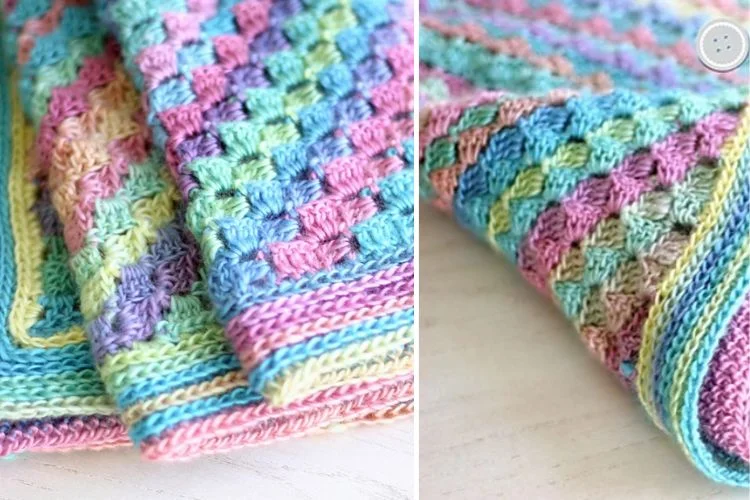 Colorful crocheted blanket with detailed stitch patterns.