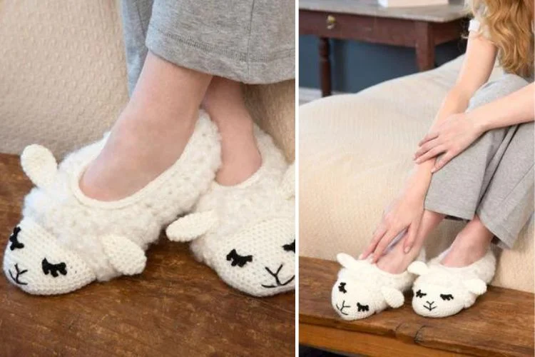 A person wearing cozy sheep-designed slippers while seated on the edge of a bed.