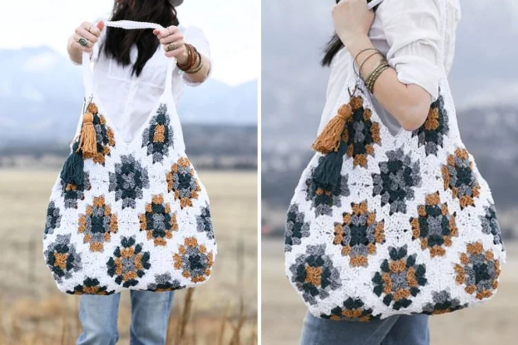 A person holding a large crochet shoulder bag with orange and black floral patterns on a white background, set against a mountainous backdrop.