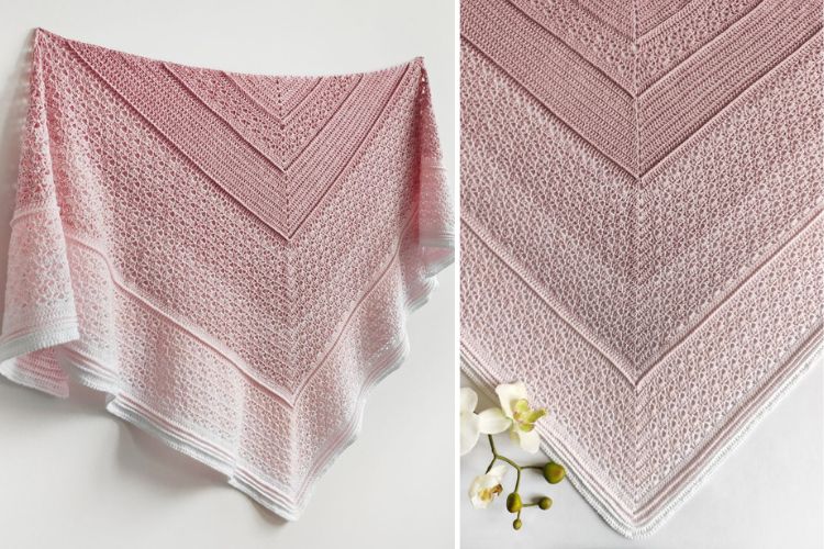 Hand-knit pink and white triangular shawl with a delicate lace pattern, displayed flat with an orchid accent.