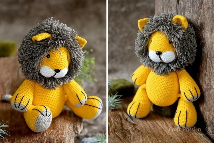 Handmade crochet lion toy with a gray mane sitting on a wooden surface.