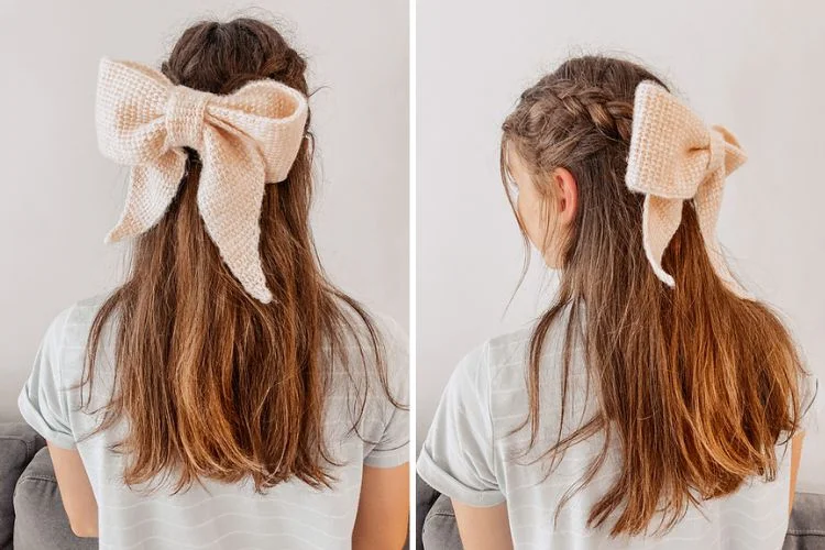 A person from the back wearing a beige bow hair accessory in their ponytail.