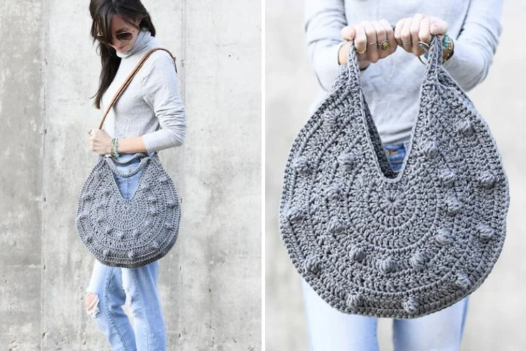 a woman wearing a round grey crochet bag with bobble texture