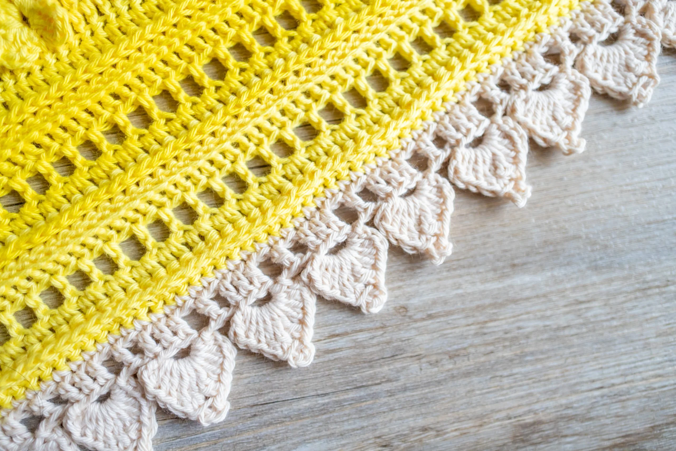 close up of white and yellow crochet border 