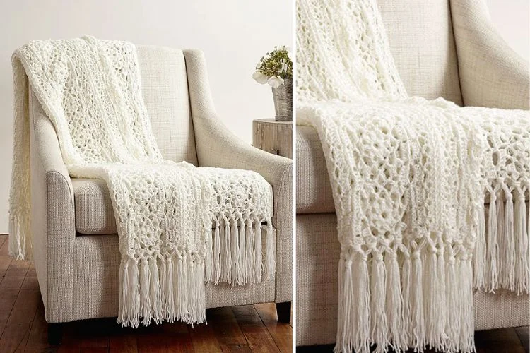 a white lace crochet blanekt with tassels