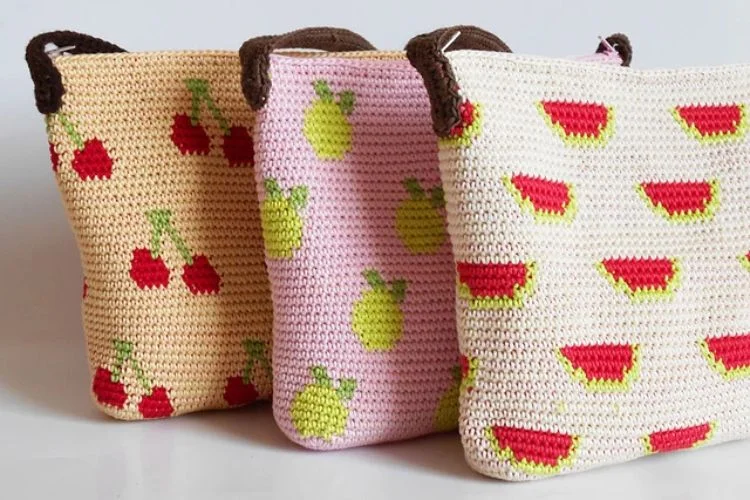 three crochet tote bags with fruit motifs