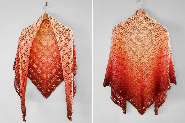 a crochet shawl in a peach color on a hanger