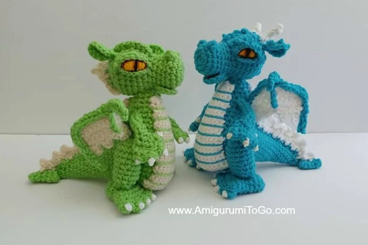 two crochet dragon amigurumi in green and blue