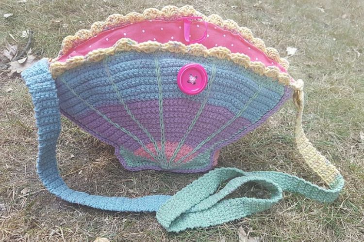 a crochet bag shaped like a seashell