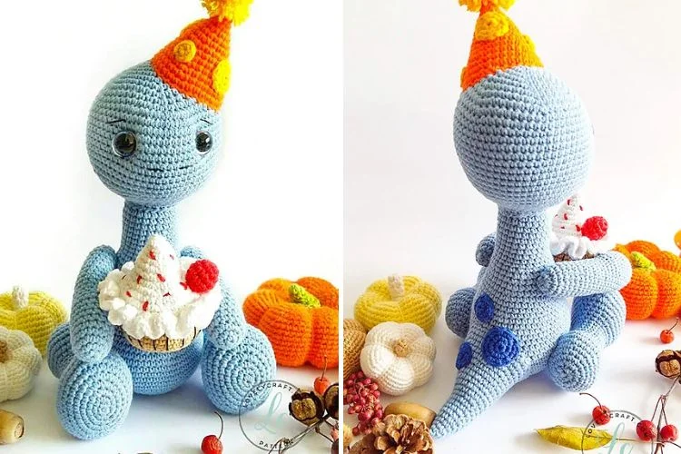 a crochet dinosaur amigurumi with a birthday hat