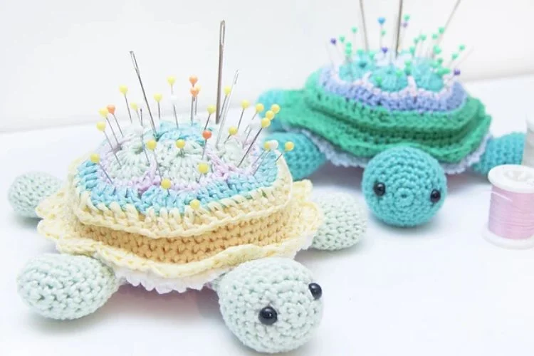 a crocheted turtle pincushion