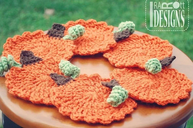 a set of crochet pumpkin coasters