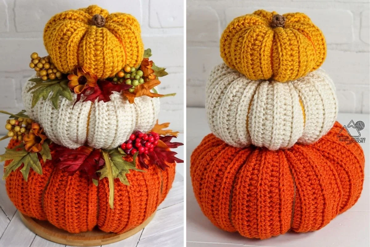 A charming centerpiece featuring a stacked trio of crocheted pumpkins in orange, white, and yellow, adorned with faux autumn leaves and berries, set against a pristine white background.