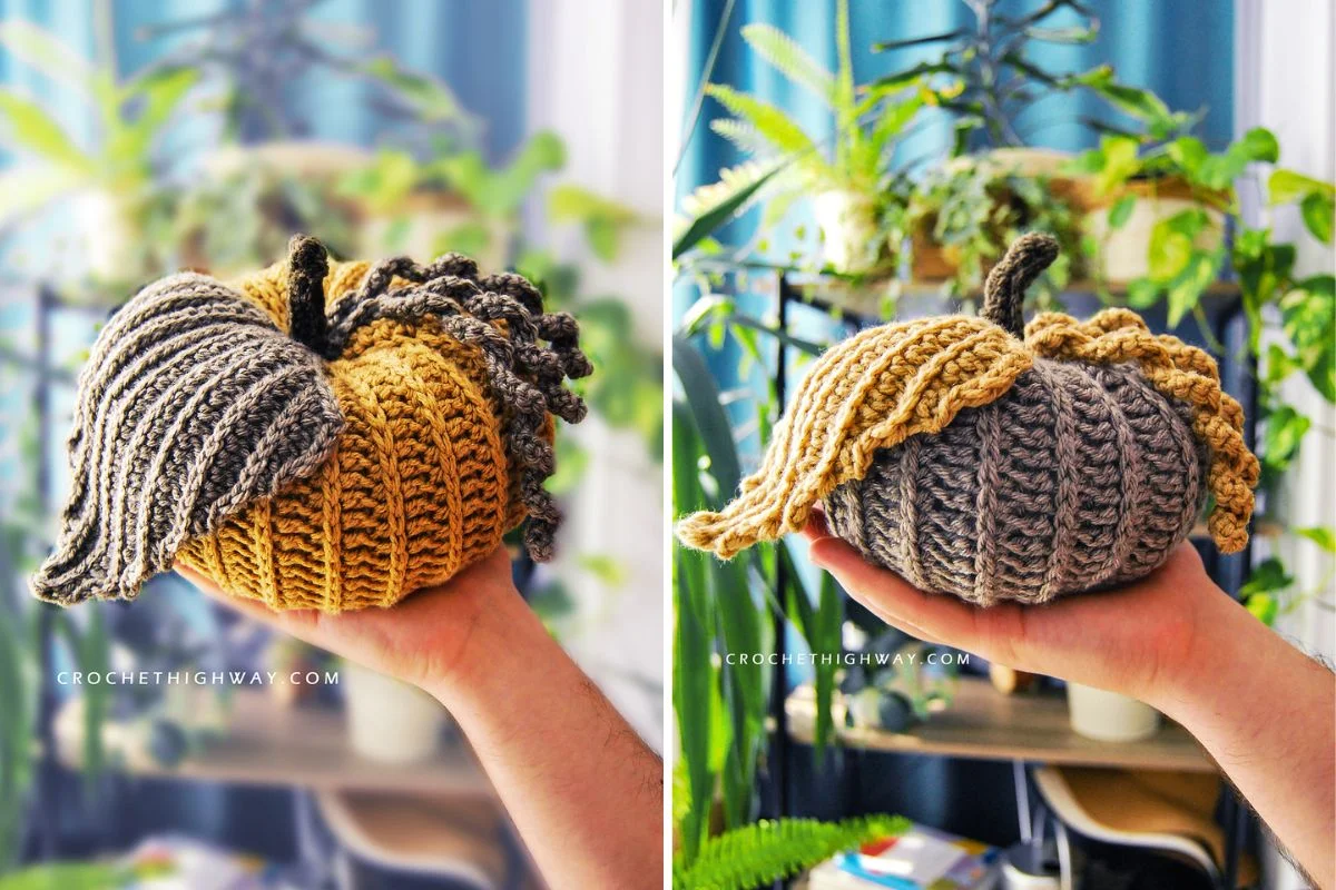 Two hands hold knitted pumpkins: one is gray and orange with textured ridges, the other gray and mustard adorned with large knit details. Green plants flourish in the background, creating a cozy scene that's as perfect for an autumn snapshot as it is for your next auto draft collection.