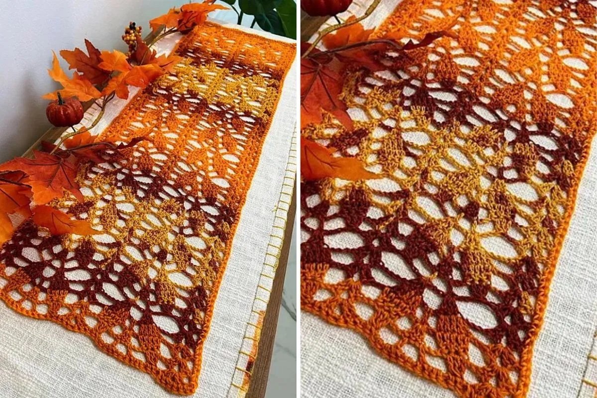 The crocheted table runner in autumn hues of orange and brown graces a white table adorned with decorative fall leaves and small pumpkins, setting the perfect Thanksgiving table decor.