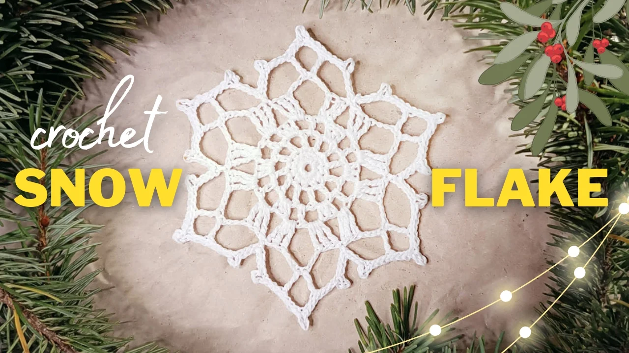 The Noelle crochet snowflake pattern, elegantly framed by fir branches and mistletoe, glistens amidst decorative lights.