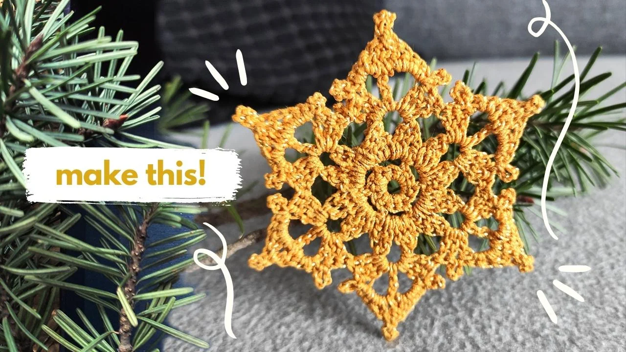 Yellow crochet snowflake delicately mimics a crystal star, resting on pine branches with the text "make this!" elegantly positioned to the left.