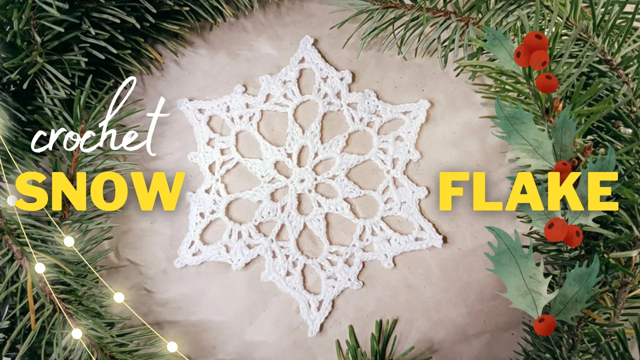 Noelle Crochet Snowflake delicately rests on a light background, encircled by lush green pine branches adorned with red berries and twinkling lights. Text reads "crochet SNOW FLAKE.