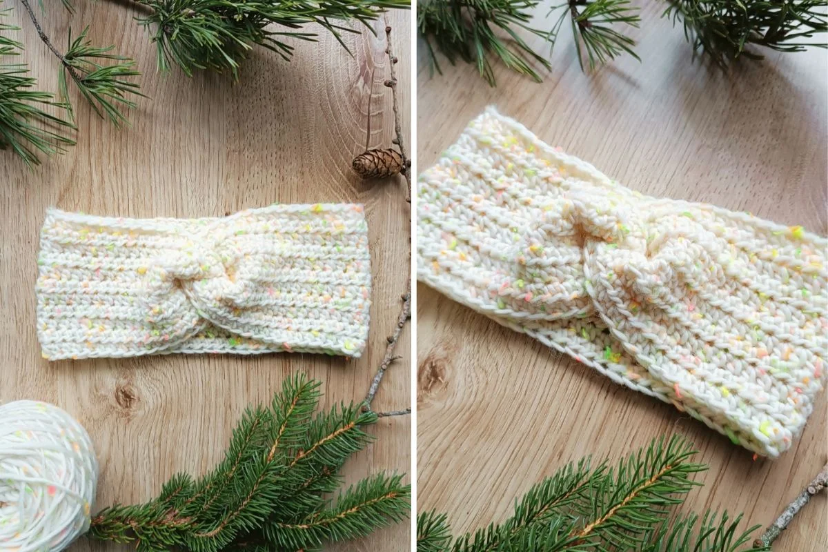 Crochet headband with a twisted knot in cream yarn, displayed on a wooden surface with pine branches and a yarn ball.