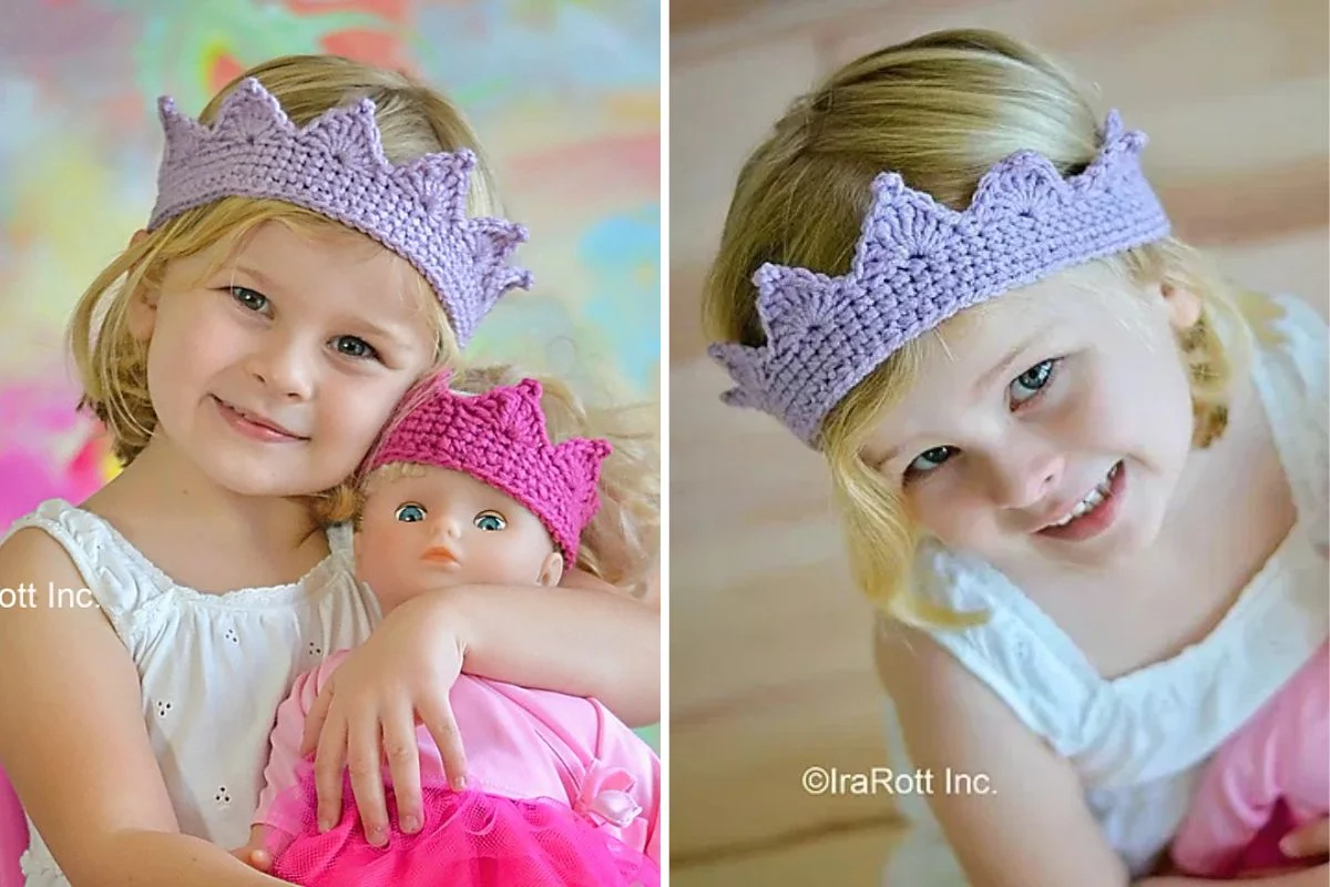 A young girl wearing a crocheted purple crown poses with a doll wearing a pink crown.