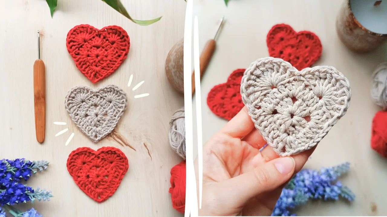 Crocheted heart patterns in red and beige adorn a light surface, accompanied by a crochet hook and yarn. A hand carefully holds a beige heart. Purple flowers bloom in the lower left corner, while hints of a crochet granny square add an extra touch of charm to the scene.