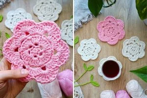 a set of crochet flower coasters in pink and white