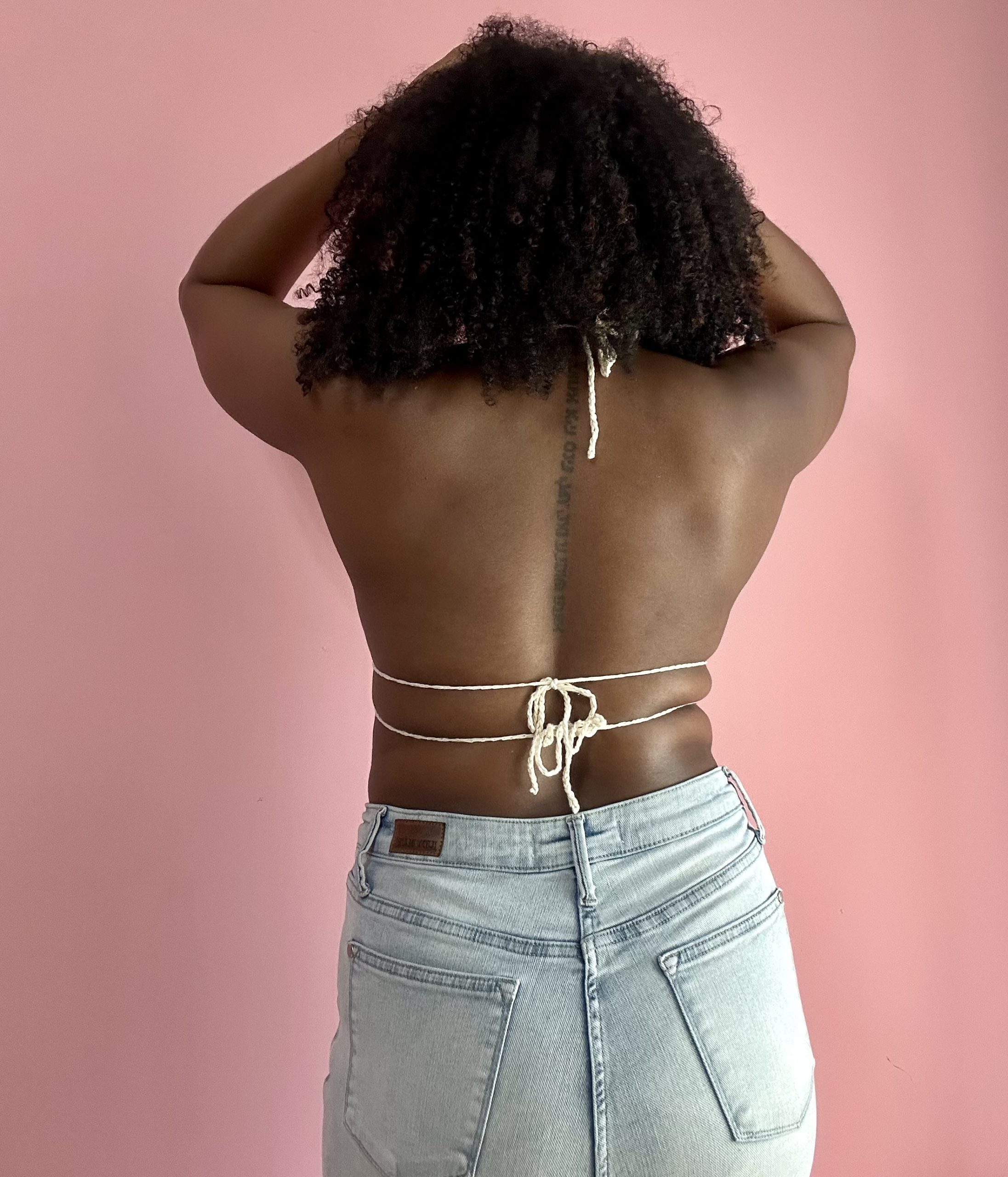 back of a woman wearing crochet top